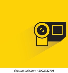 video camera with shadow on yellow background