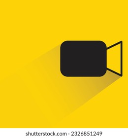 video camera with shadow on yellow background