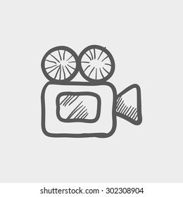 Video camera sketch icon for web and mobile. Hand drawn vector dark grey icon on light grey background.