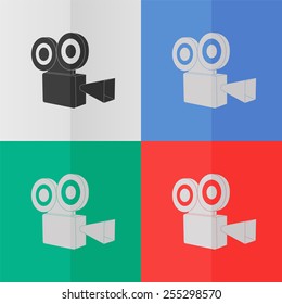 Video camera vector icon. Effect of folded paper. Colored (red, blue, green) illustrations. Flat design