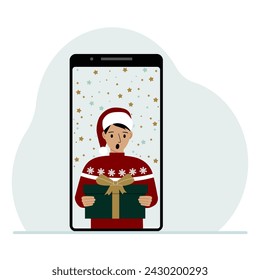 Video congratulations Merry Christmas or New Year. Mobile phone with a man in a red cap with a gift box. The concept of a safe celebration, online congratulations.
