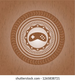 video game icon inside badge with wood background