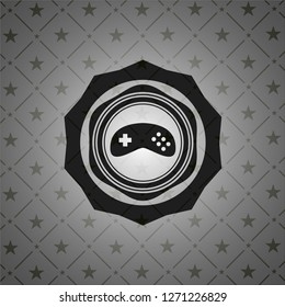 video game icon inside black emblem