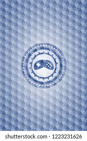 video game icon inside blue emblem with geometric background.