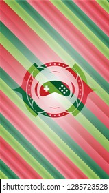 video game icon inside christmas style emblem.