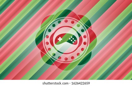 video game icon inside christmas style emblem.