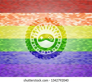 video game icon inside emblem on mosaic background with the colors of the LGBT flag
