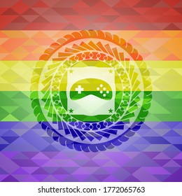 video game icon inside emblem on mosaic background with the colors of the LGBT flag. 