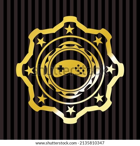 video game icon inside gold emblem. 
