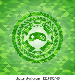 video game icon inside green emblem. Mosaic background