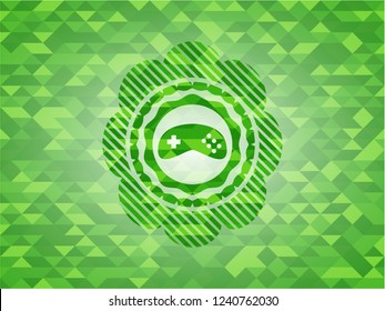 video game icon inside green emblem. Mosaic background