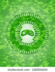 video game icon inside green emblem with mosaic background