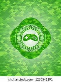 video game icon inside green mosaic emblem
