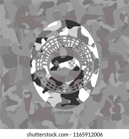 video game icon inside grey camouflage emblem