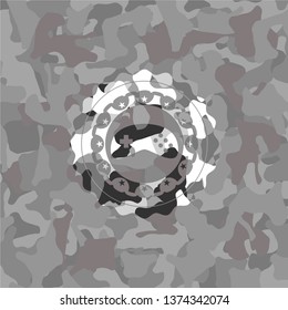 video game icon inside grey camouflage texture