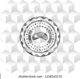 video game icon inside realistic grey emblem with cube white background