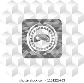 video game icon inside realistic grey emblem with geometric cube white background