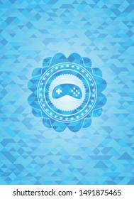 video game icon inside realistic light blue mosaic emblem