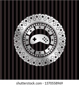 video game icon inside silver emblem or badge