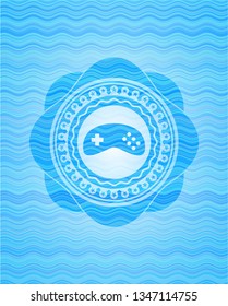 video game icon inside sky blue water wave emblem.