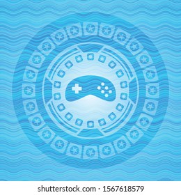 video game icon inside sky blue water wave emblem.