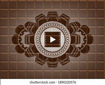 video icon inside chocolate realistic badge. Brown classic background. Artistic illustration. 