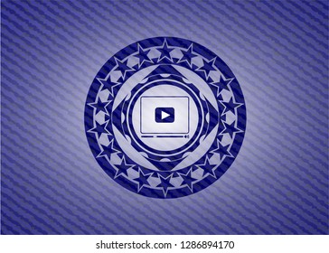 video player icon inside badge with jean texture