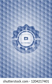 video player icon inside blue emblem or badge with abstract geometric pattern background.