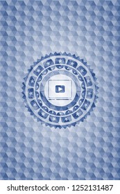 video player icon inside blue badge with geometric pattern.