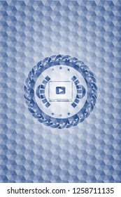 video player icon inside blue hexagon emblem.