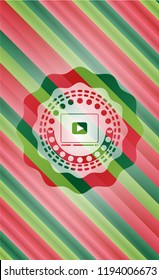 video player icon inside christmas colors badge.