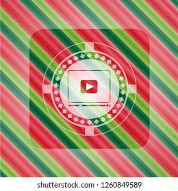 video player icon inside christmas emblem.