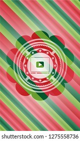 video player icon inside christmas style badge..