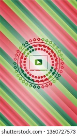 video player icon inside christmas colors style emblem.