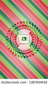 video player icon inside christmas style badge..