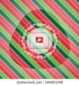 video player icon inside christmas badge background.