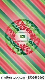 video player icon inside christmas colors emblem.