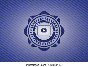 video player icon inside emblem with denim texture