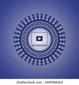 video player icon inside emblem with denim texture