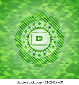 video player icon inside green emblem with mosaic ecological style background