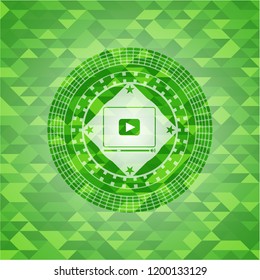 video player icon inside green emblem. Mosaic background