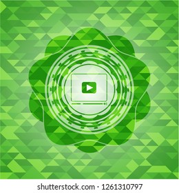 video player icon inside green emblem with mosaic background