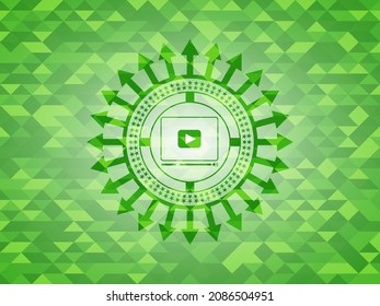 video player icon inside green emblem with mosaic background. 