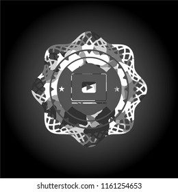 video player icon inside grey camouflage emblem