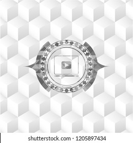 video player icon inside grey badge with geometric cube white background