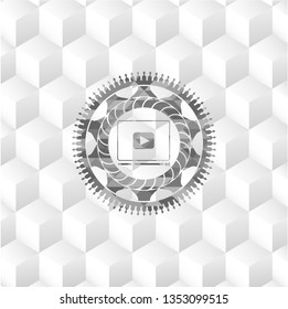 video player icon inside grey badge with geometric cube white background