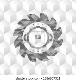 video player icon inside grey badge with geometric cube white background