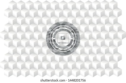 video player icon inside grey emblem with cube white background