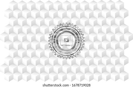 video player icon inside grey emblem with geometric cube white background
