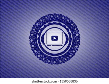 video player icon inside jean or denim emblem or badge background